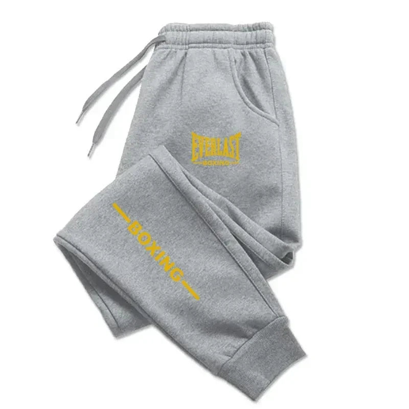 Gray sweatpants with yellow 'Everlast Boxing' logo on a white background