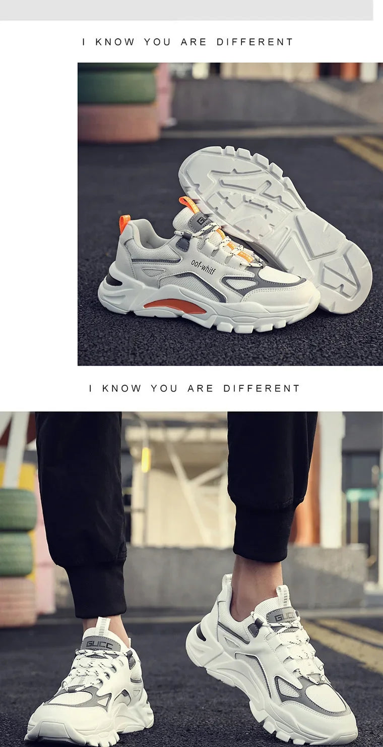 White sneakers with orange accents worn by a person on a street.