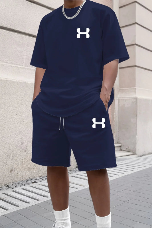 Person wearing navy Under Armour outfit with brand logo on a stone building background