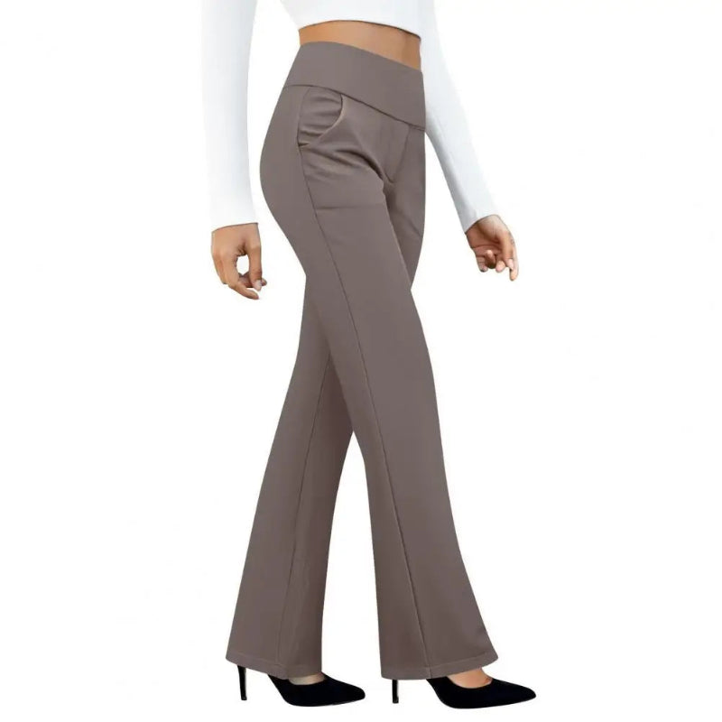 Brown flared pants worn by a person on a white background