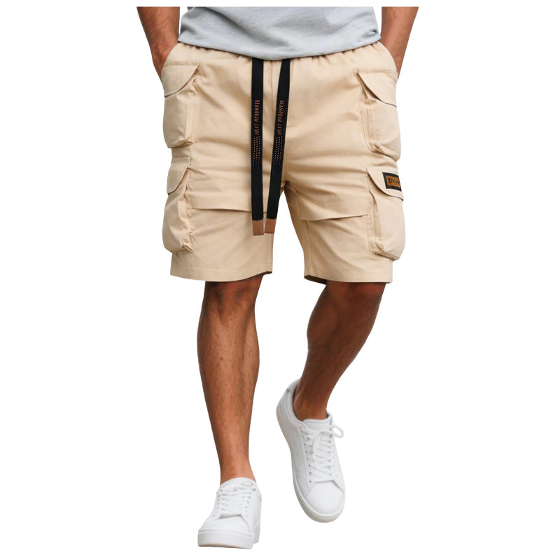 Beige cargo shorts with a black zipper on a white background