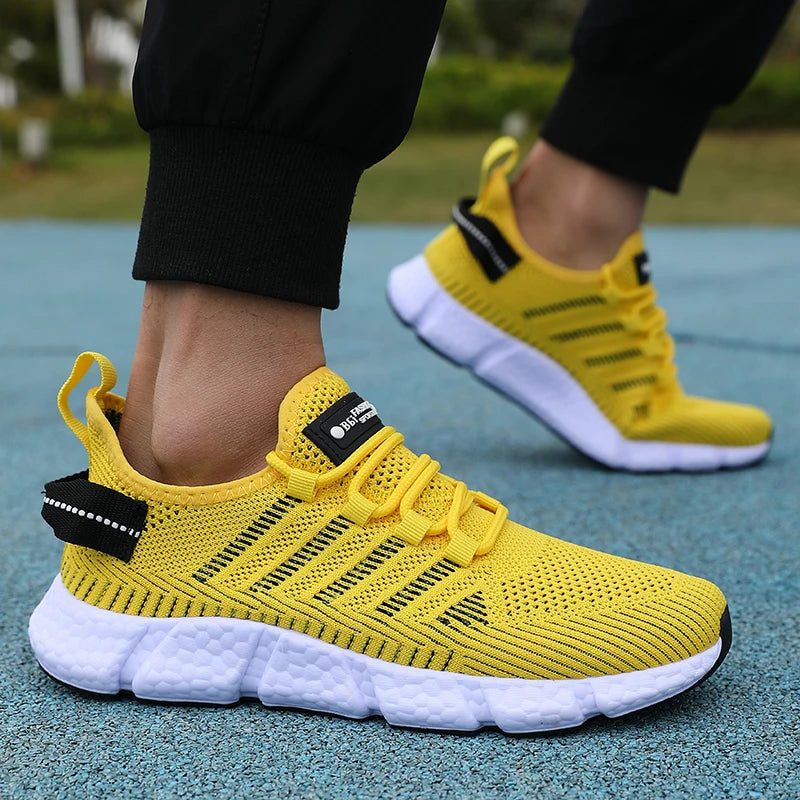 Yellow running shoes with black accents on a blue track