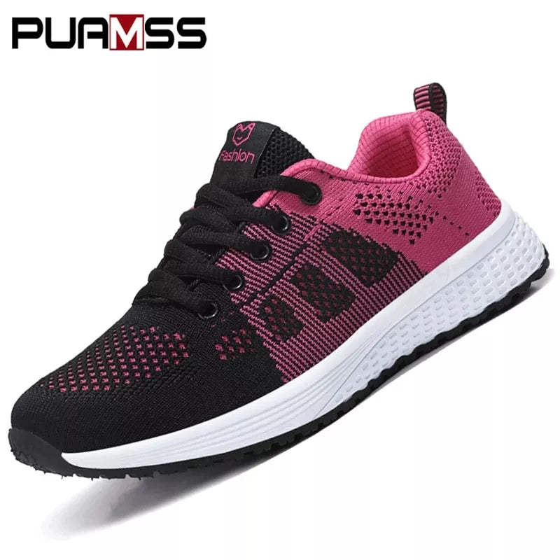 Black and pink running shoes with 'Puma' branding on a white background