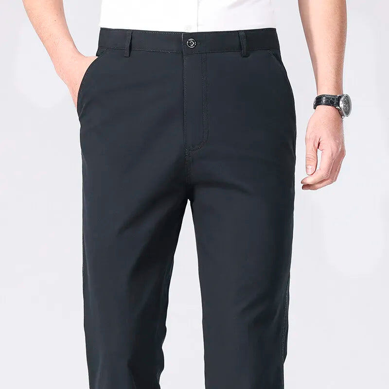 Black pants worn by a person on a white background