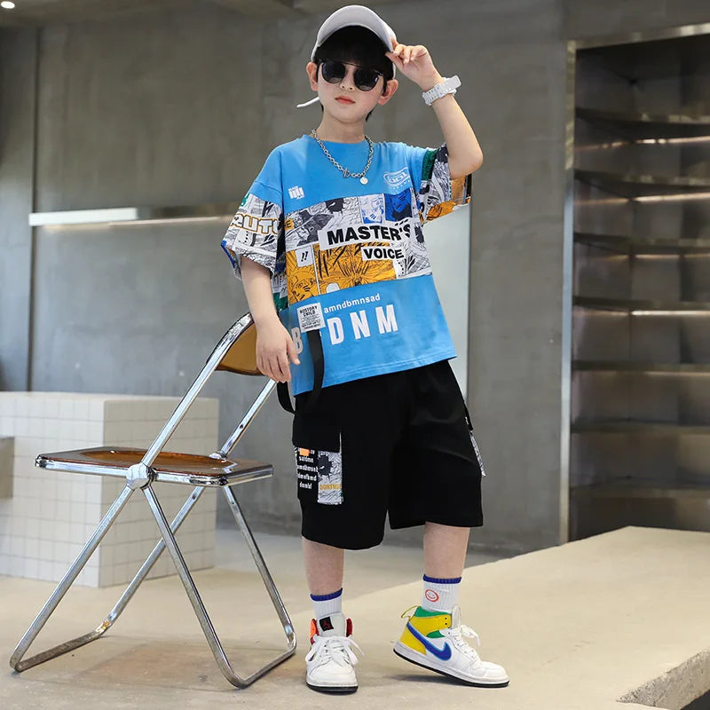 Child wearing a blue graphic t-shirt and black shorts in an indoor setting