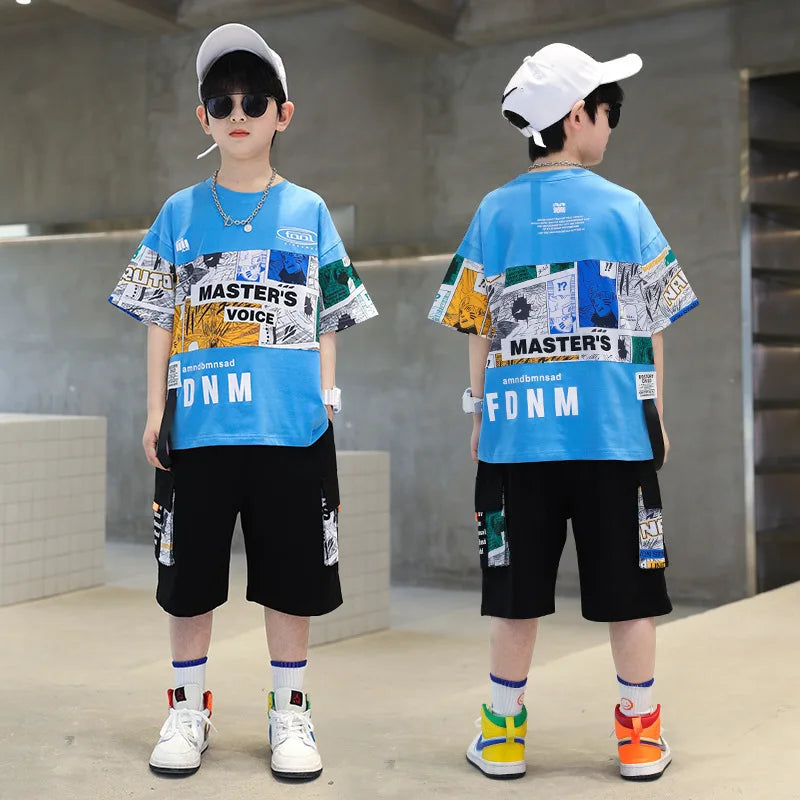 Two children wearing matching blue graphic t-shirts and black shorts in an indoor setting.