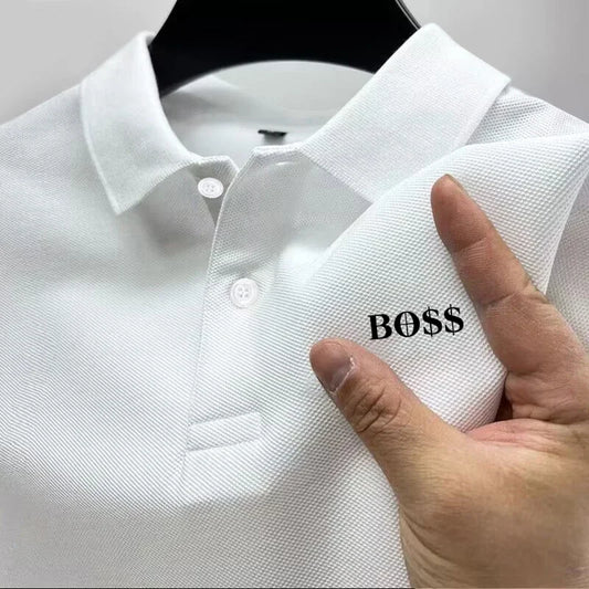 White polo shirt with 'BOSS' logo held by a hand on a gray background