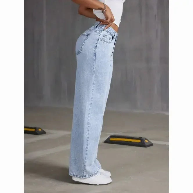 Light blue jeans worn by a person on a plain background