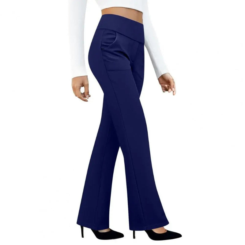 Navy blue flared pants worn by a person on a white background