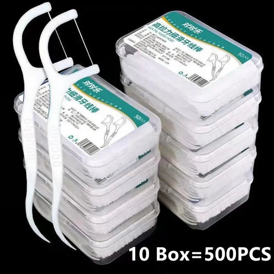 Stack of dental floss boxes with a white floss holder on a black background