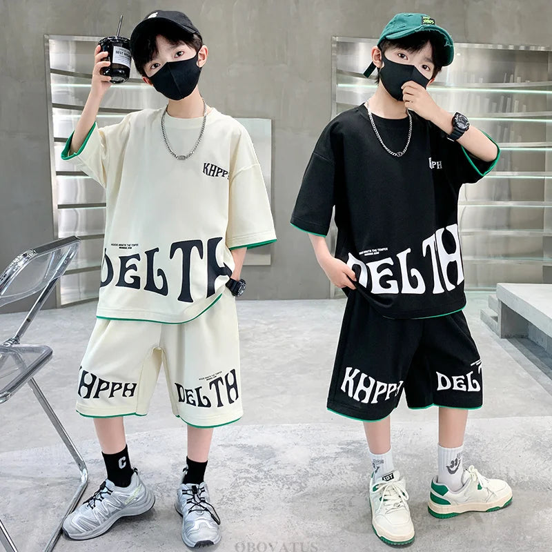 Two children wearing matching outfits with 'DELT' and 'KPPH' text in an urban setting.