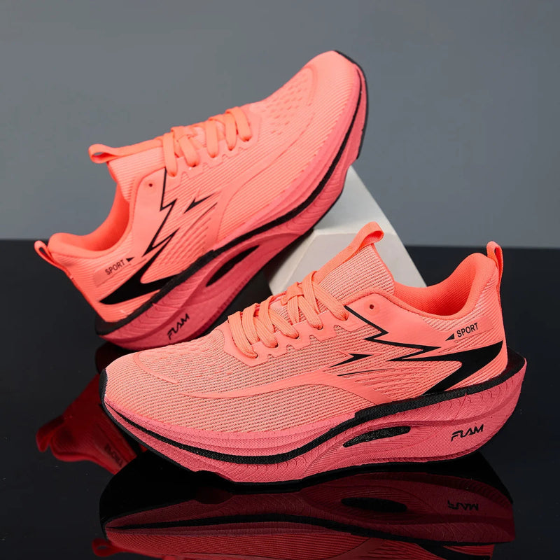 Pair of pink running shoes with black accents on a reflective surface.