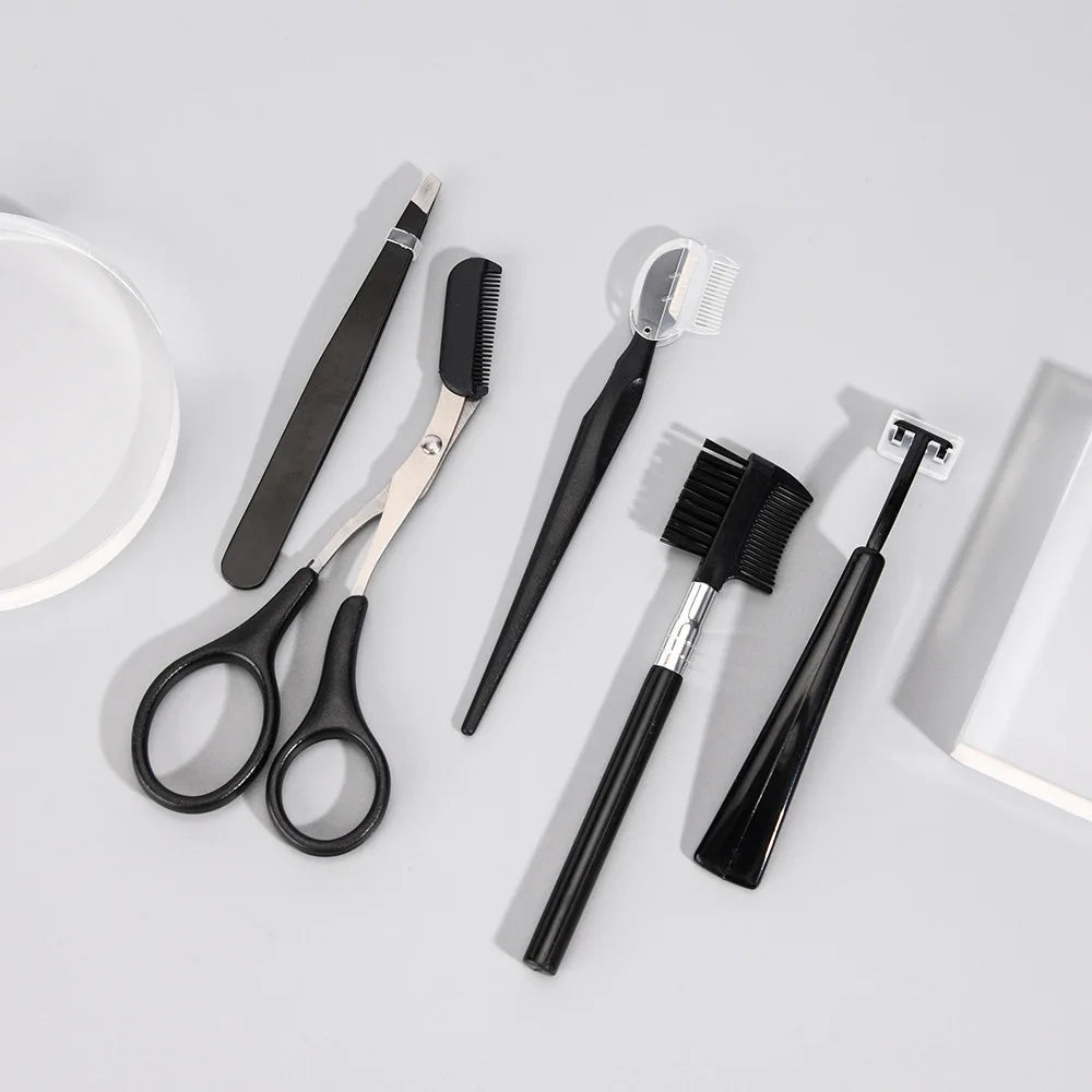 Set of black grooming tools including scissors, combs, and brushes on a light gray background