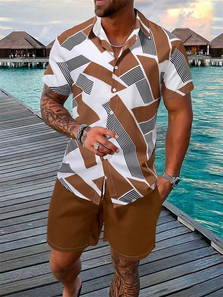 Man wearing a patterned shirt and shorts standing on a wooden dock by water.