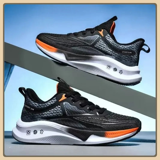 Black and orange running shoes with white soles on a blue and gray background