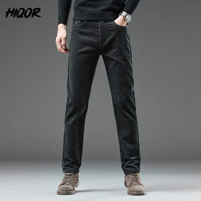 Person wearing black pants with a gray background and 'HIQOR' branding.