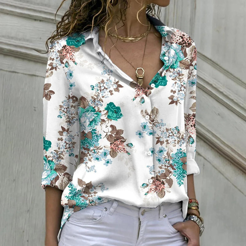 Woman wearing a floral blouse with a neutral background