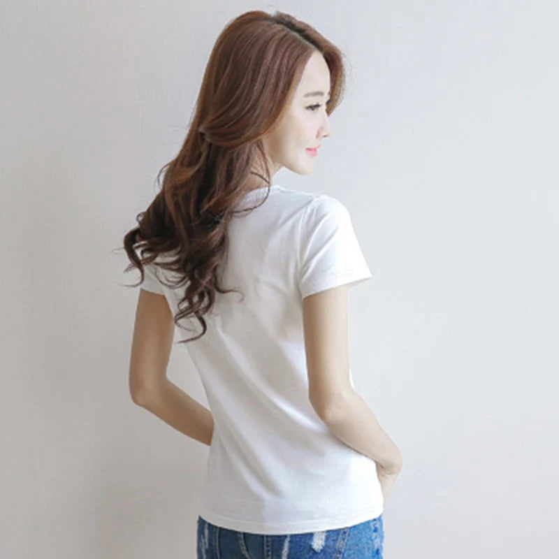 Woman wearing a white t-shirt against a plain background