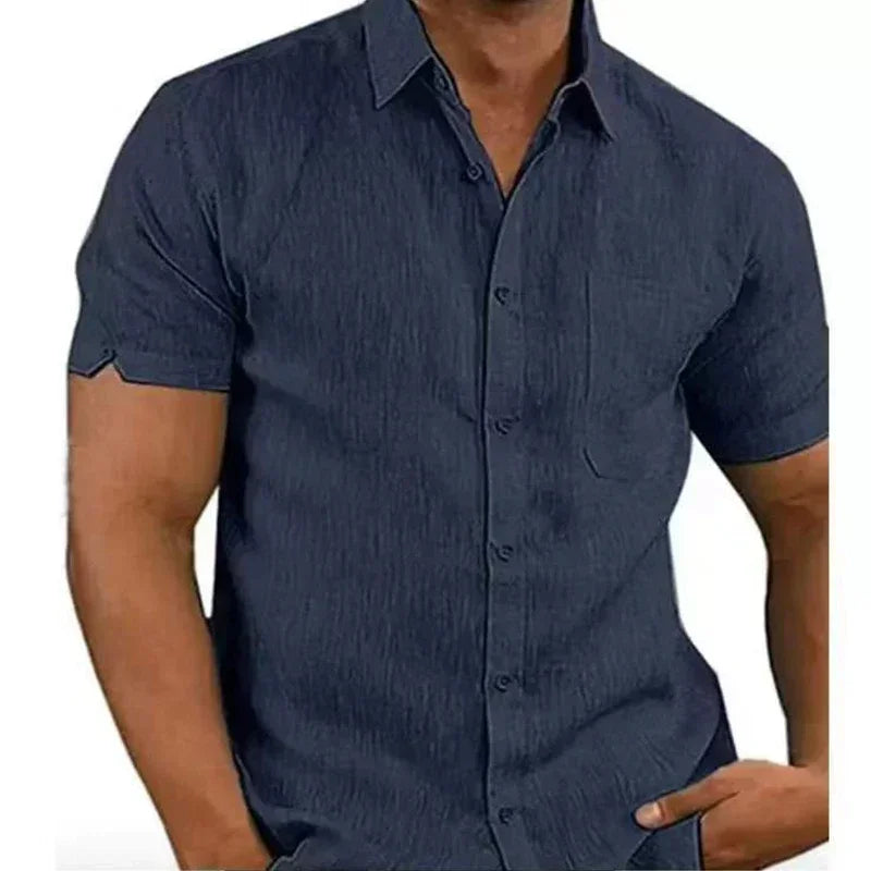 Navy blue short-sleeve shirt worn by a person on a white background