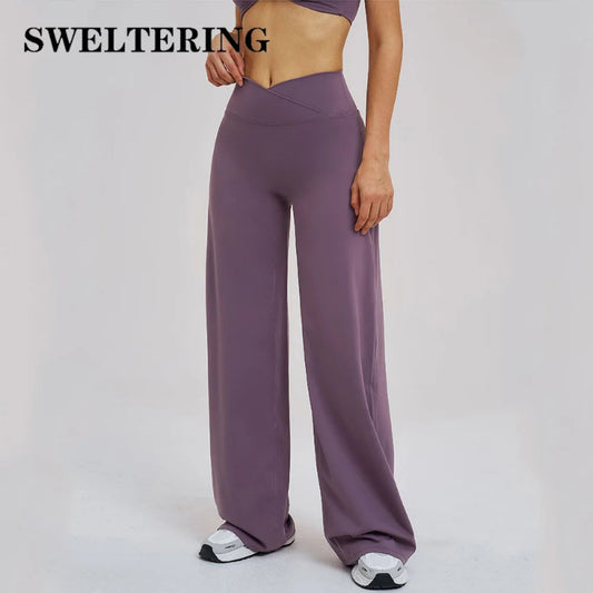 Purple high-waisted pants worn by a person on a plain background with 'SWELTERING' branding.