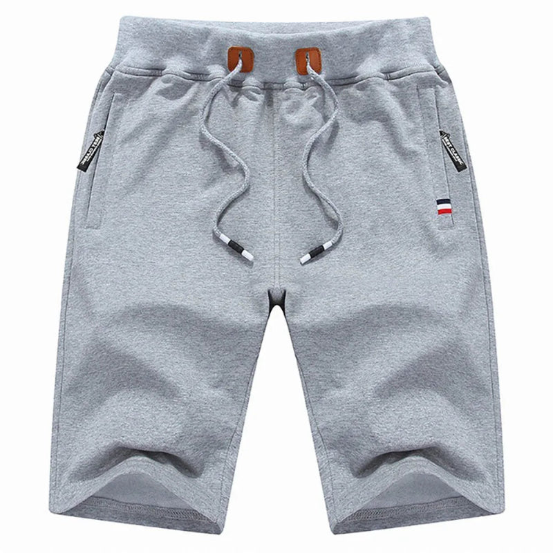 Gray shorts with drawstring and small flags on a white background