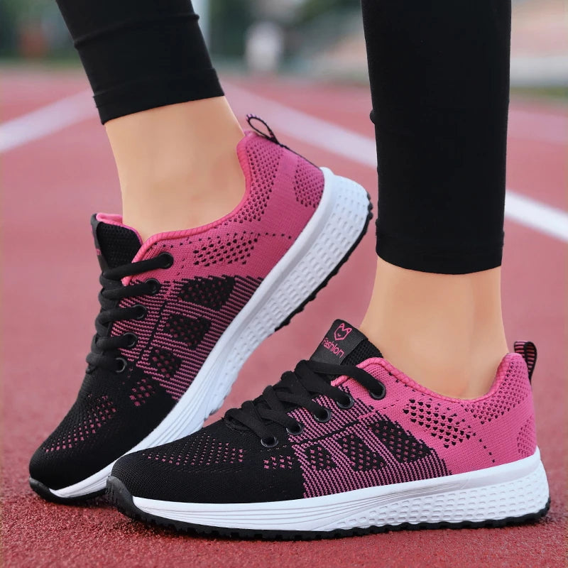 Black and pink running shoes on a track