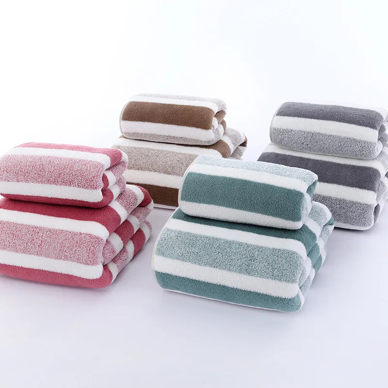 Stacks of striped towels in various colors on a white background