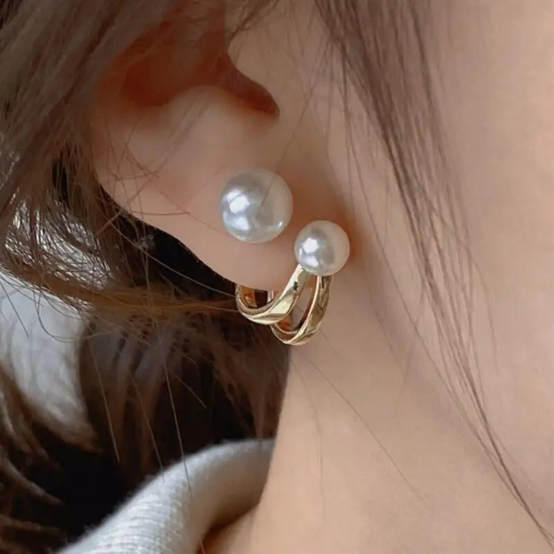 Pearl earrings with gold hoop on an ear