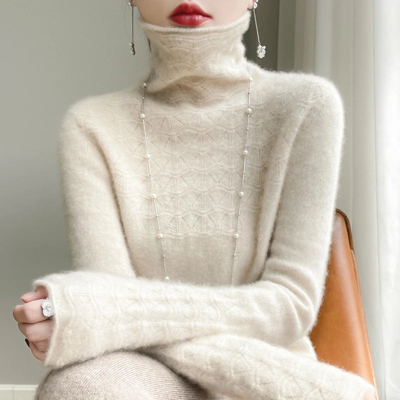 Close-up of a person wearing a beige turtleneck sweater with pearl embellishments.
