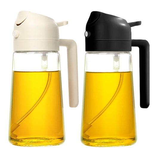 Two glass oil dispensers with white and black lids filled with yellow liquid on a white background.