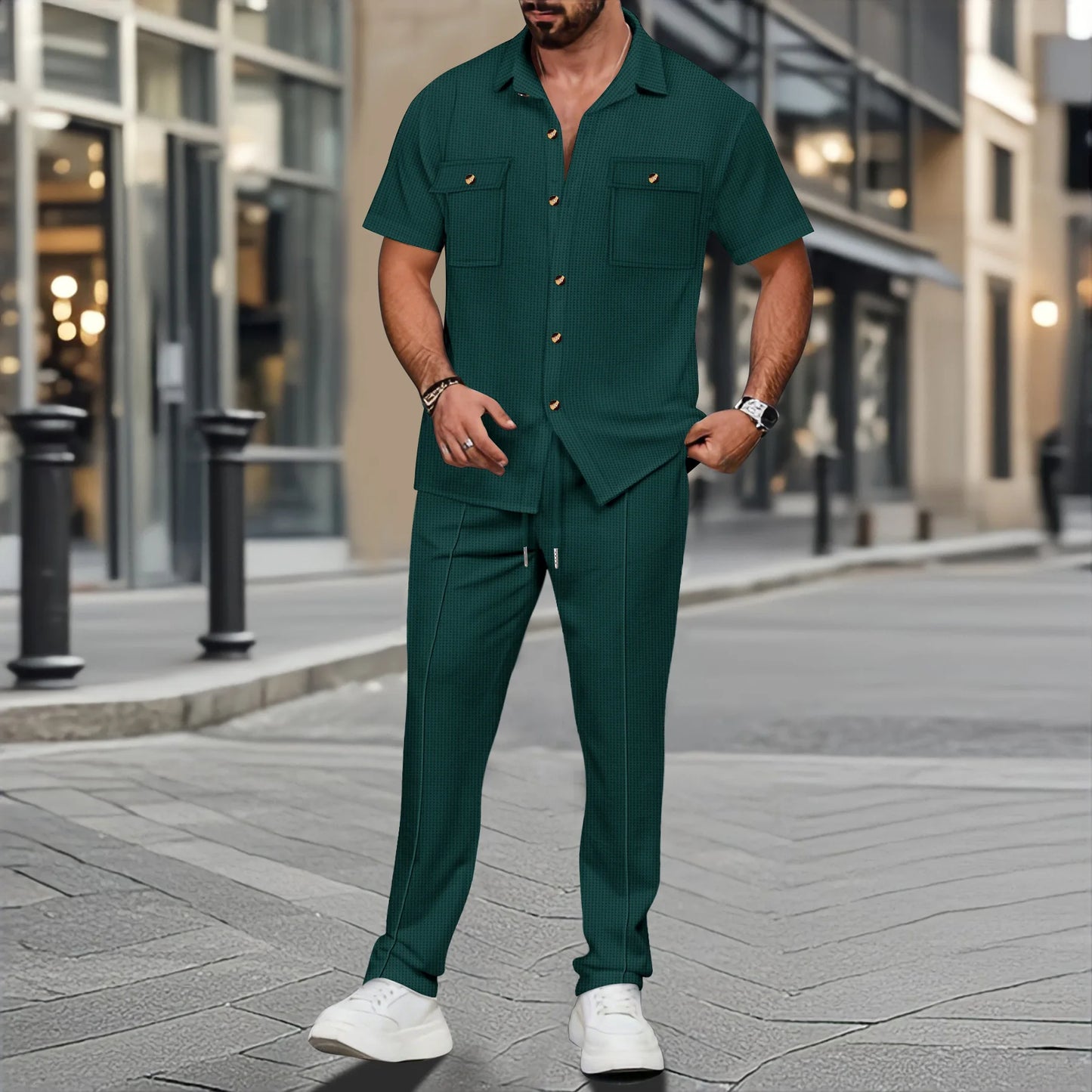 Man wearing a green outfit standing on a city street.