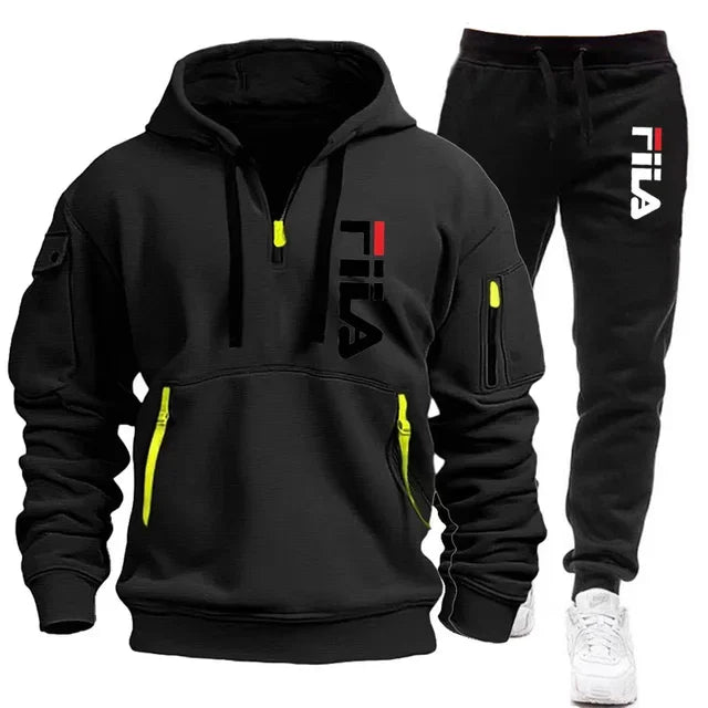 Black FILA hoodie and pants set with yellow accents on a white background