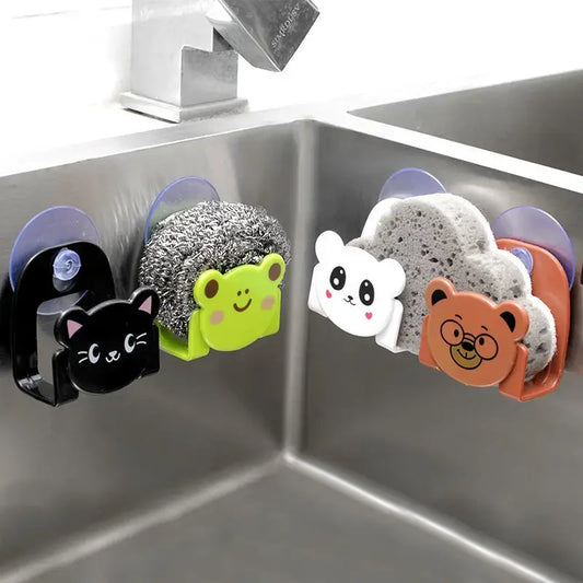 Set of kitchen sponges with animal-themed holders attached to a sink.