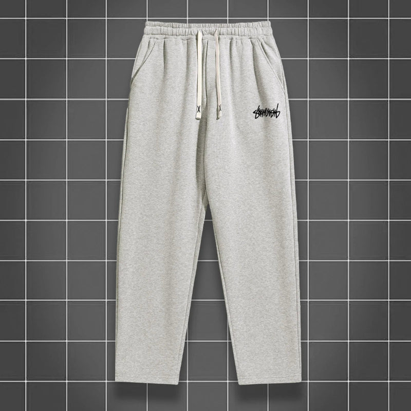 Gray sweatpants with a logo on a grid background