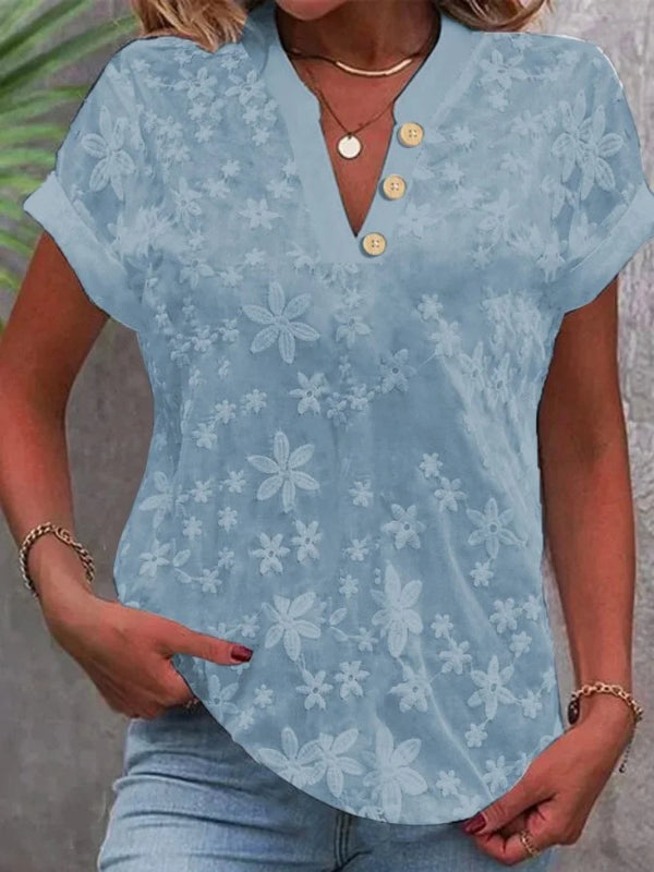 Light blue floral blouse worn by a person with a neutral background