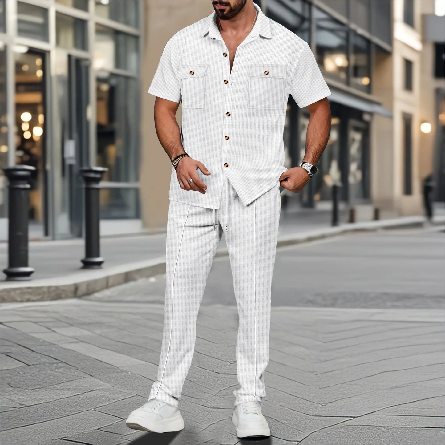 Man in a white outfit standing on a city street