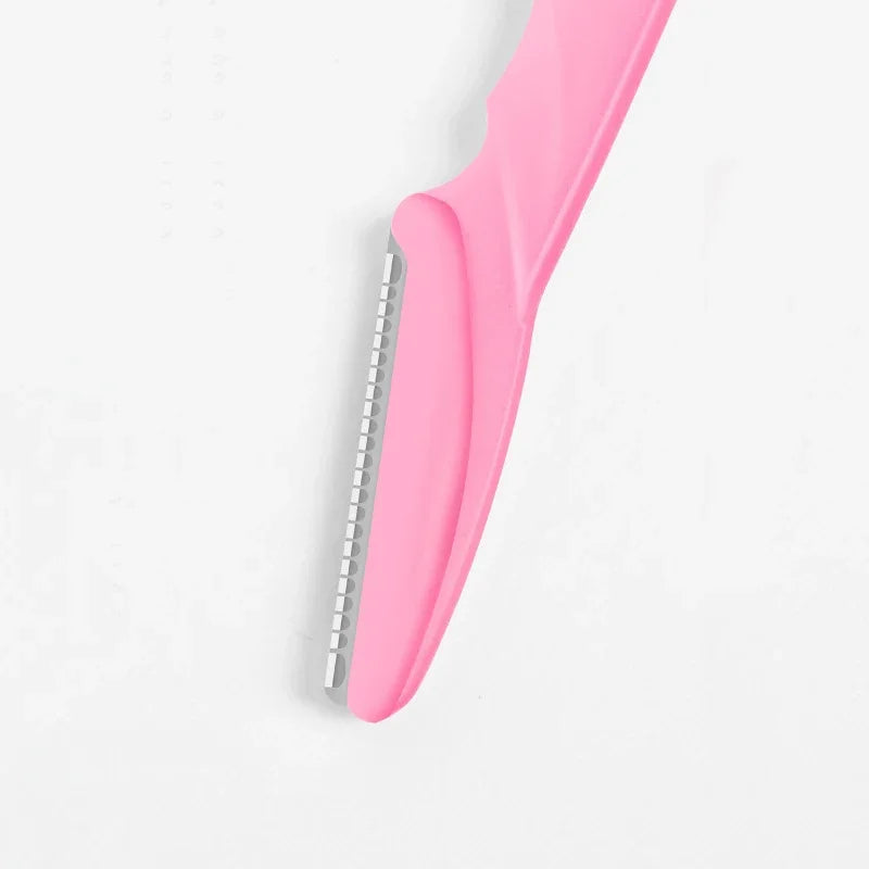 Pink comb with metal teeth on a light gray background