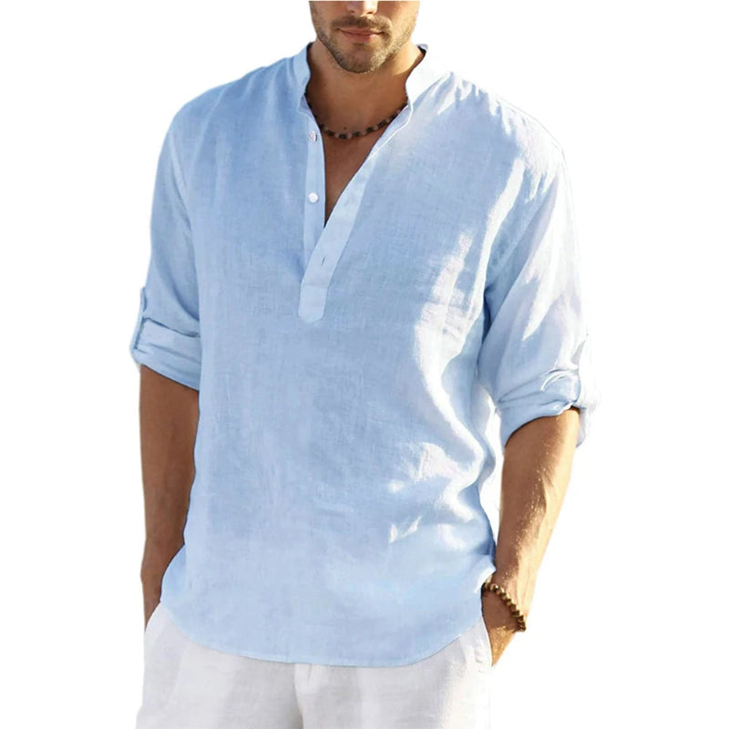 Man wearing a light blue shirt with rolled-up sleeves on a white background