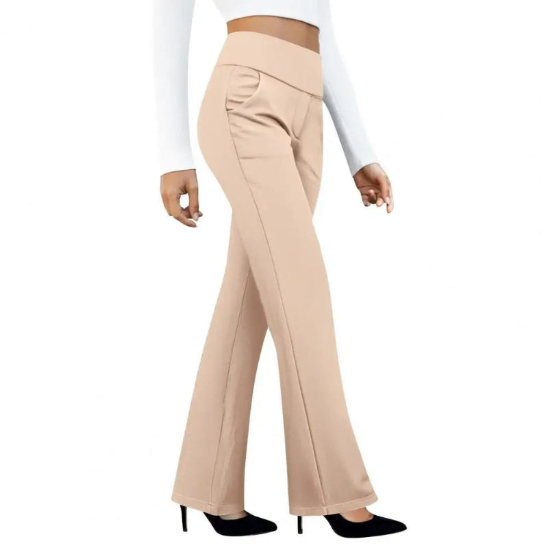 Beige flared pants worn by a person on a white background