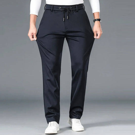 Black pants worn by a person on a gray background