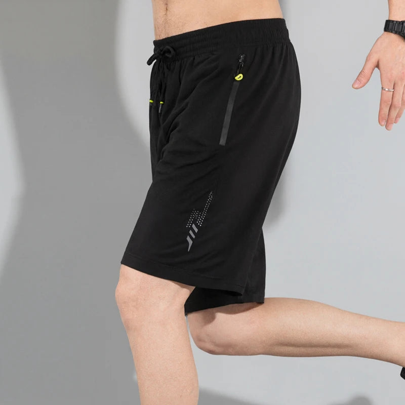 Black athletic shorts with a brand logo on a gray background