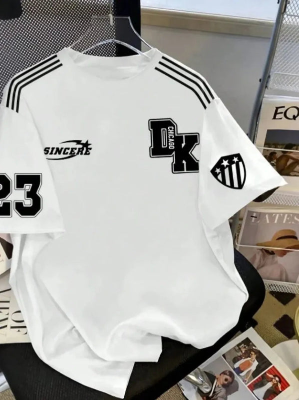 White t-shirt with black graphics and text on a table