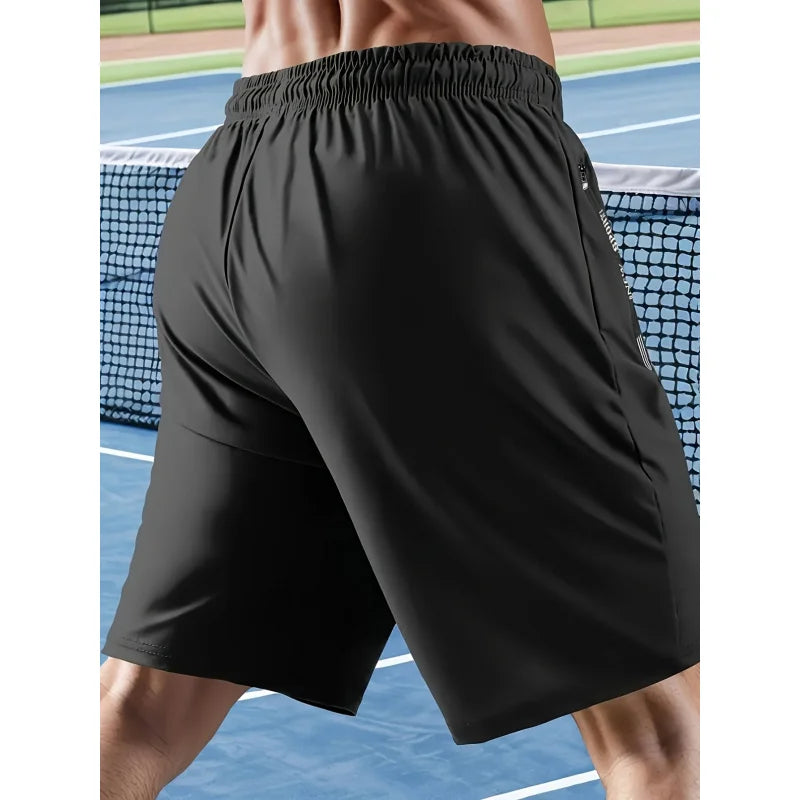Person wearing black shorts on a tennis court