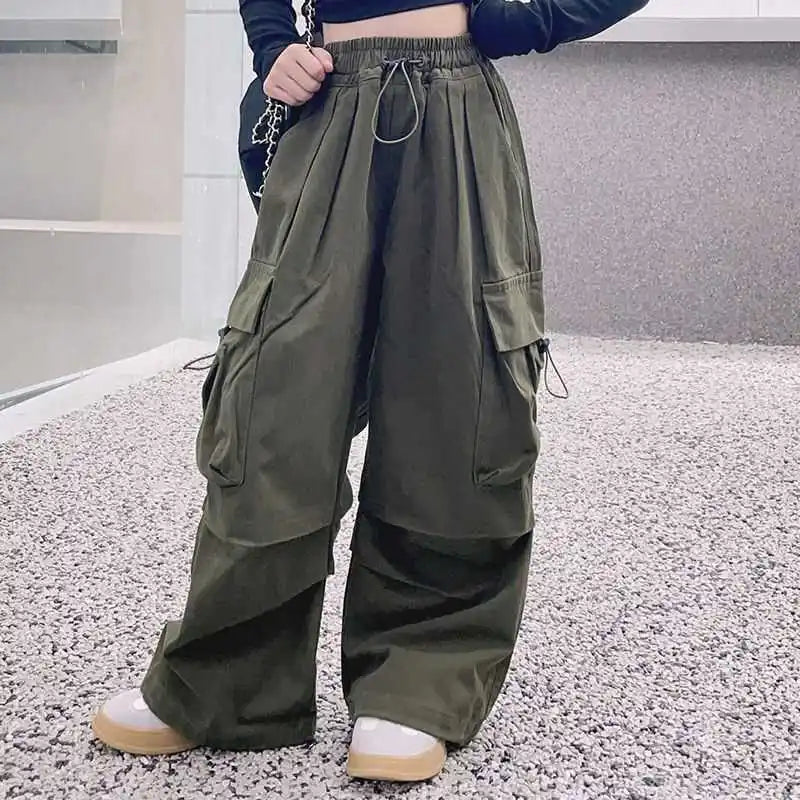 Person wearing olive green cargo pants in an indoor setting