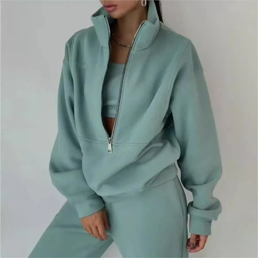 Light blue tracksuit worn by a person on a plain background