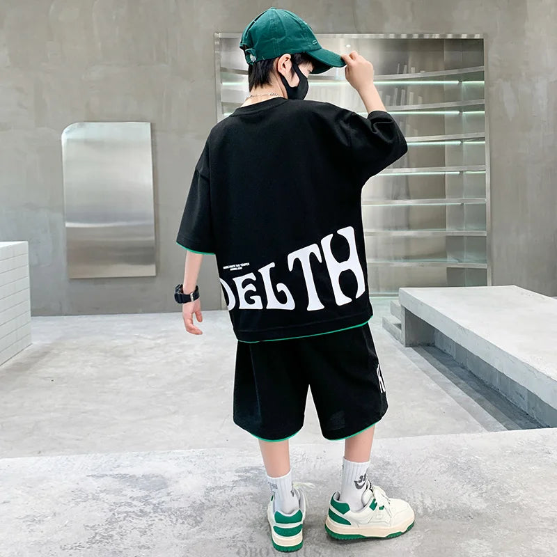 Person wearing a black outfit with 'DELTA' branding in a modern indoor setting.