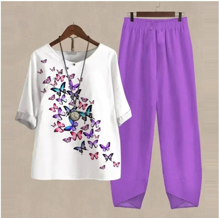 White shirt with butterfly design and purple pants on a beige background