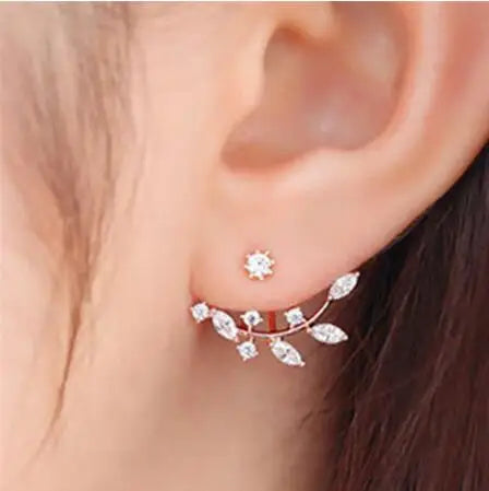 Close-up of an ear wearing a decorative earring with a small stud.