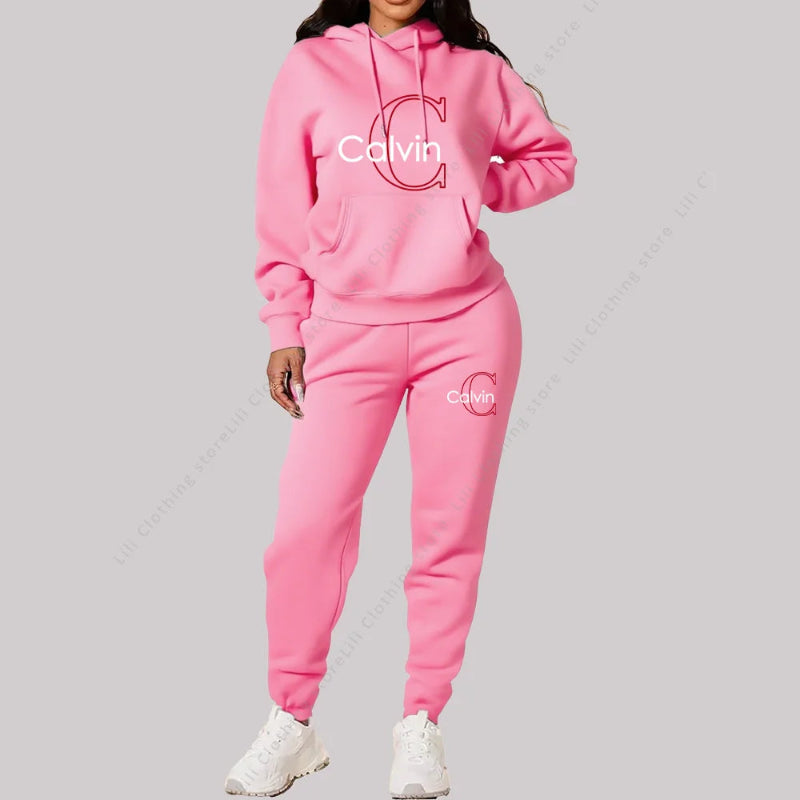 Person wearing a pink Calvin tracksuit on a gray background