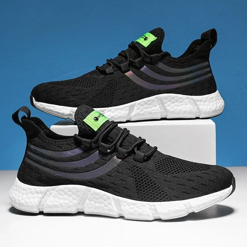 Black and white running shoes with green accents on a blue background